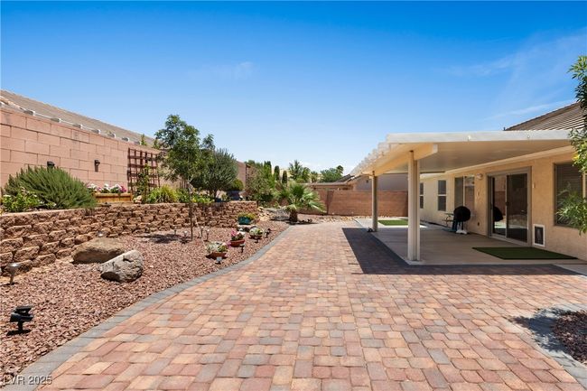 Fenced backyard with a patio area | Image 39