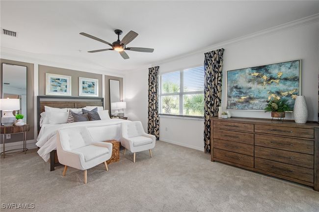 Bedroom featuring visible vents, baseboards, ornamental molding, ceiling fan, and light colored carpet | Image 12