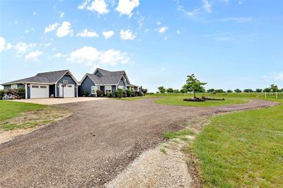 View of front of property featuring a garage and a front yard | Image 1