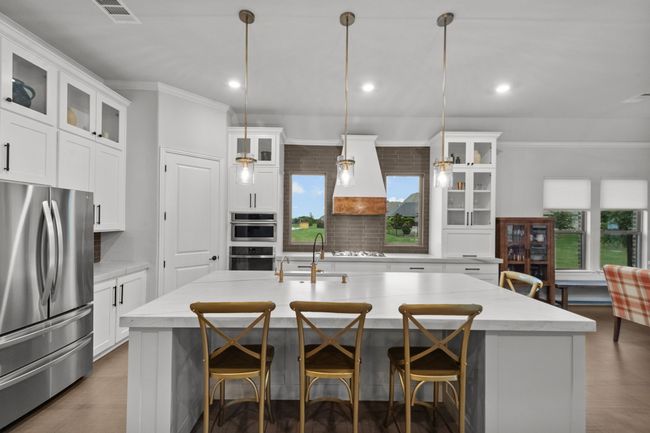 Gourmet kitchen with center island and designer pendant lights | Image 14