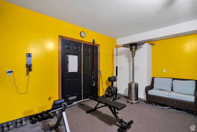 Workout room with baseboards and a textured ceiling | Image 35