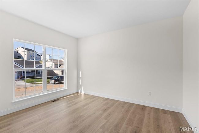 Spare room with light wood-type flooring and baseboards | Image 25