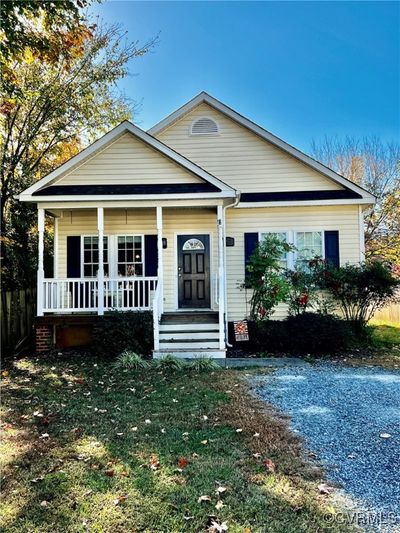 View of front of property with a porch and a front yard | Image 1