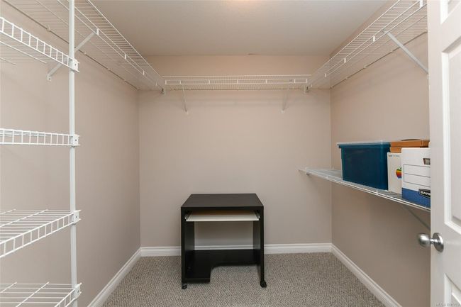 Full bath with a baseboard radiator, vanity, a stall shower, toilet, and tile patterned floors | Image 11