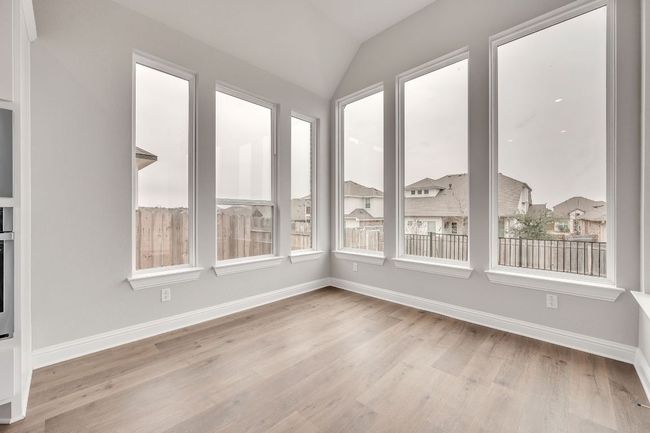 Unfurnished sunroom featuring lofted ceiling | Image 14