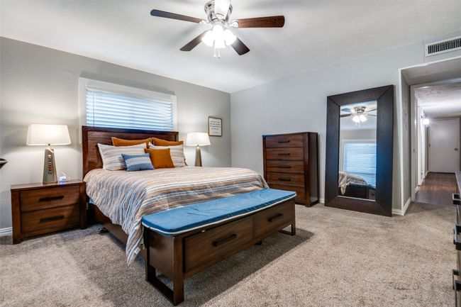 Light and bright Primary Bedroom with carpeted floor and a ceiling fan | Image 15
