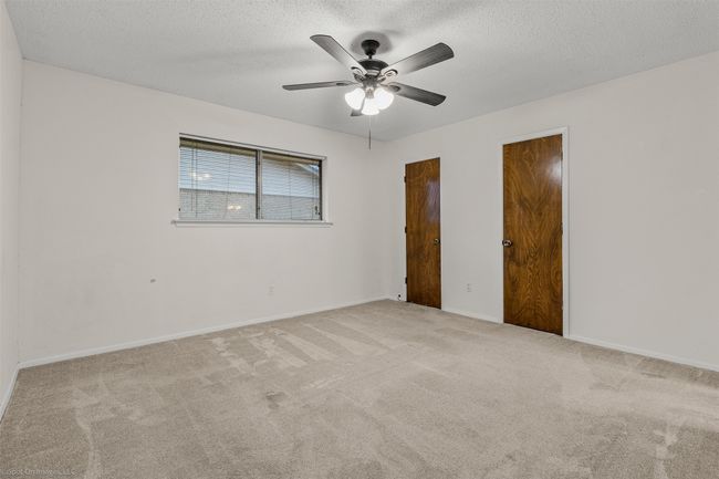 Spare room with carpet, a textured ceiling, ceiling fan, and baseboards | Image 17