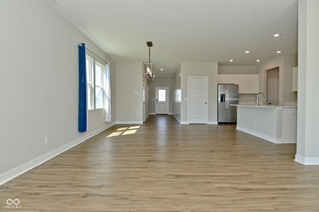 unfurnished living room with recessed lighting, a sink, light wood-type flooring, and baseboards | Image 8
