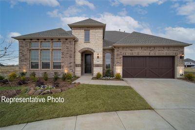 View of front facade featuring a front yard and a garage | Image 1