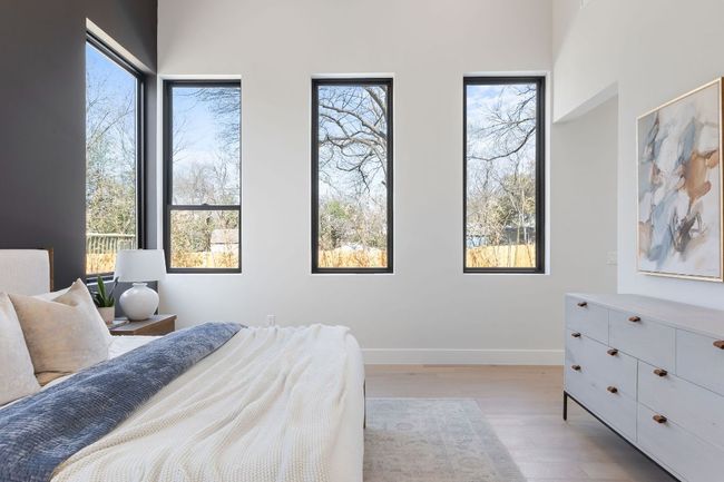 Bedroom featuring wood finished floors and baseboards | Image 25