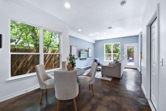 Dining space featuring healthy amount of natural light, concrete flooring, recessed lighting, and baseboards | Image 4