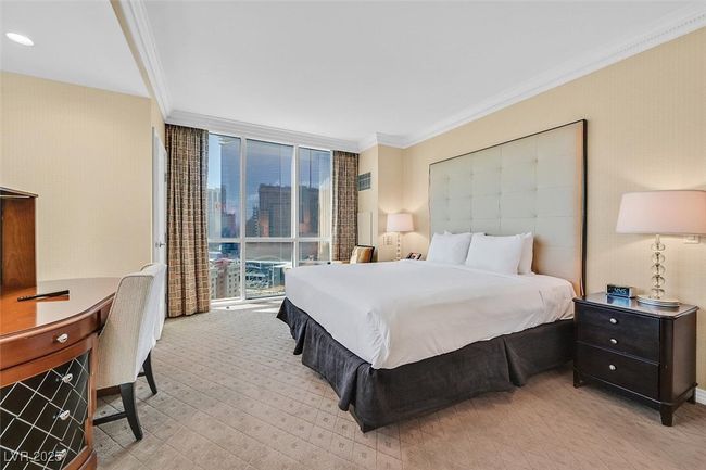 Bedroom featuring expansive windows, crown molding, and light colored carpet | Image 32
