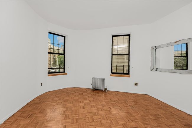 Unfurnished room featuring radiator heating unit and baseboards | Image 10