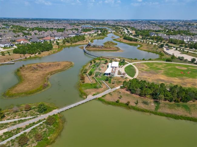 Features a single-family home with a spacious yard in Bridgeland, a master-planned community offering lakes, pools, sidewalks, and green spaces. | Image 36