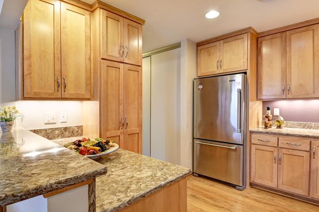 You will appreciate the additional cabinets with pull out shelving & Cambria counter | Image 11