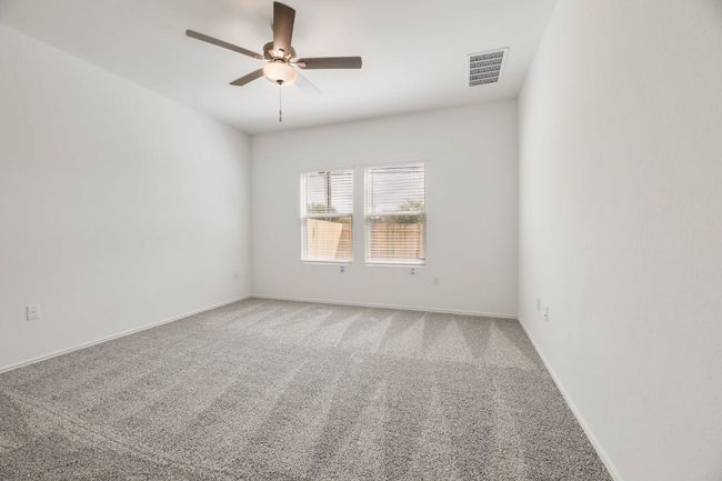 Unfurnished room with ceiling fan and carpet floors | Image 19