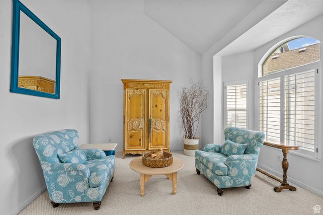 Sitting room with a healthy amount of sunlight, high vaulted ceiling, and carpet flooring | Image 22