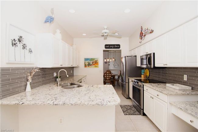 White cabinets and recessed lighting makes for a beautiful kitchen. | Image 4