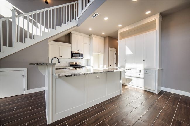 Kitchen has plenty of granite countertop space | Image 12