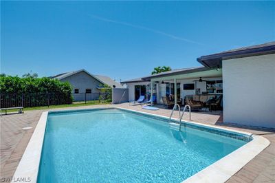 View of swimming pool with a patio | Image 2