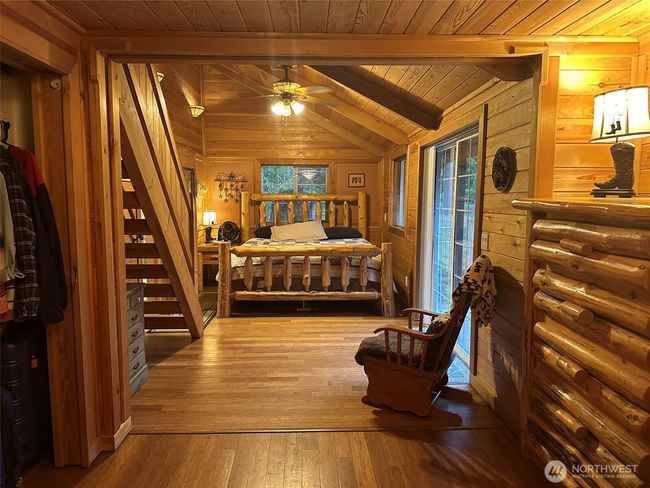 Master bedroom with access to back patio, stairs lead to loft/office. | Image 15