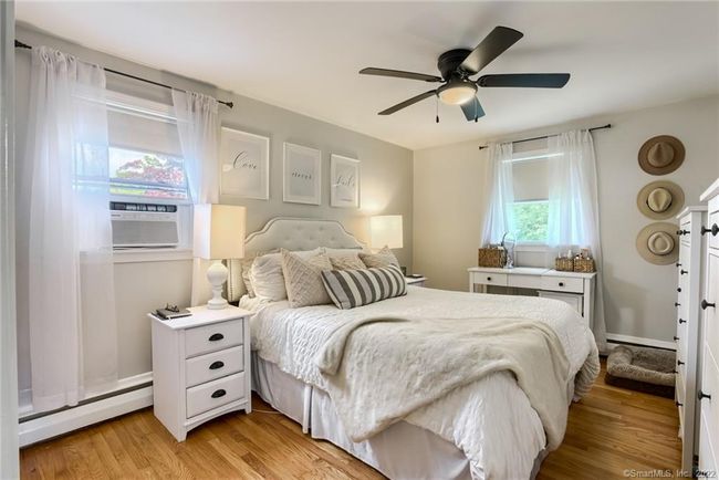 Primary bedroom with ceiling fan and hardwood floors | Image 17