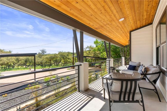 Experience the spectacular sunset views from the comfort of the expansive covered front porch. | Image 5