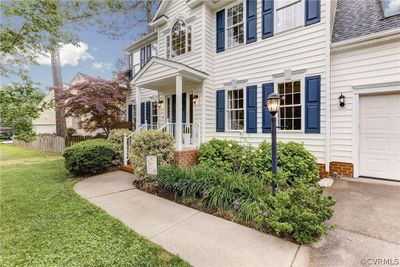 View of front of home with a front lawn and a garage | Image 3