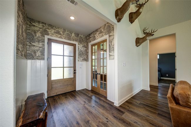 Doorway featuring french doors, a textured ceiling, and dark hardwood / wood-style flooring | Image 4