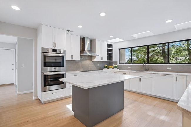 Stunning chef's kitchen wasrenovated in 2023 and is truly the heart of the home. Three skylights and multiple windows let sunshine in all day long. | Image 8