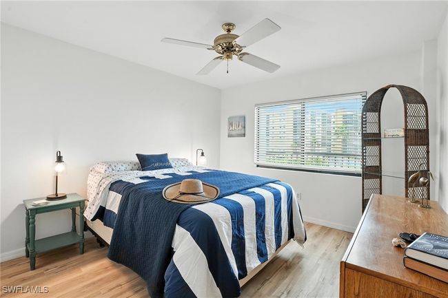 Bedroom with light wood finished floors and a ceiling fan | Image 20