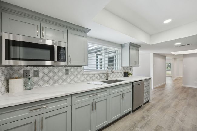 NEW microwave and dishwasher plus stylish and tasteful backsplash add to the high-end finishes! | Image 15