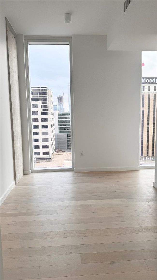 Spare room with wood finished floors, expansive windows, and baseboards | Image 10