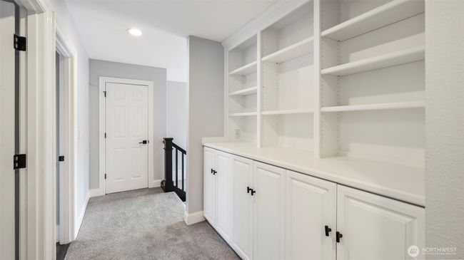 At the top of the stairs, extensive built-in shelves and cabinets provide ideal storage and organization just outside the bedrooms and bathroom, with an additional hallway closet for even more space | Image 29