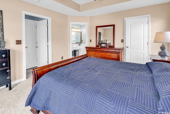 Carpeted bedroom featuring baseboards and ensuite bathroom | Image 30