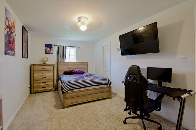 Bedroom featuring carpet and an office area | Image 21