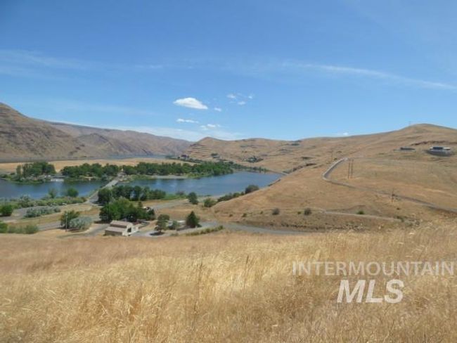 View of mountain backdrop with a large body of water | Image 17