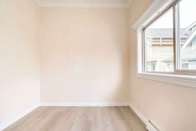 Spare room featuring light wood-type flooring and crown molding | Image 7