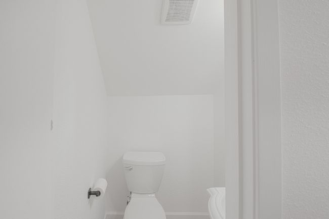 A half bathroom is located downstairs for guests. | Image 16