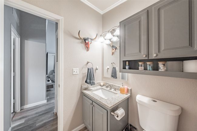 Bathroom featuring crown molding, vanity, and wood finished floors | Image 27