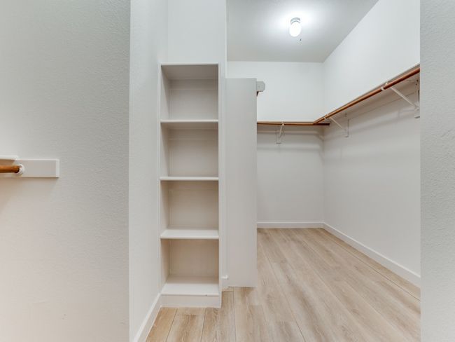 Spacious closet with wood finished floors | Image 23
