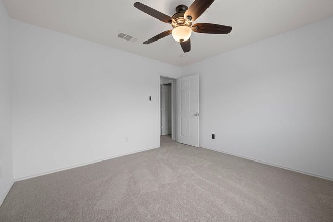 Empty room featuring light colored carpet, a ceiling fan, and baseboards | Image 21