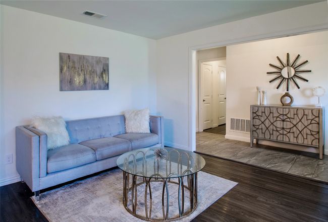 Living room with baseboards and wood finished floors | Image 6