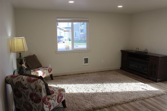 Living area with recessed lighting and wood finished floors | Image 4
