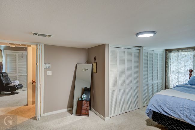 Carpeted bedroom with multiple closets and baseboards | Image 17