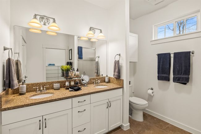 Full bathroom featuring a stall shower, double vanity, and tile patterned flooring | Image 17