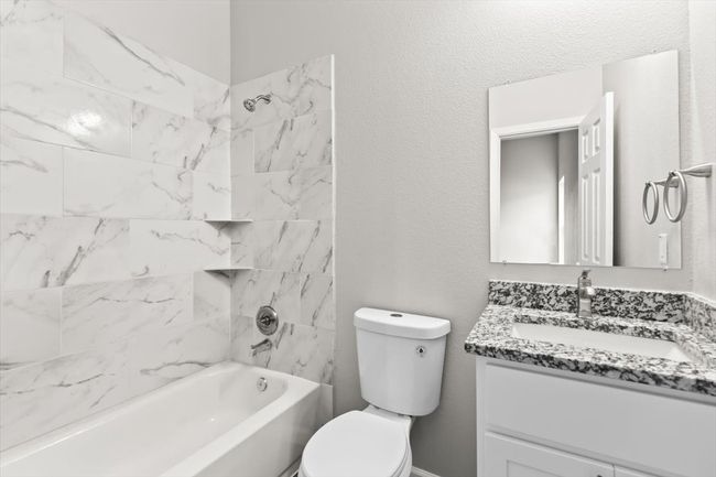 Full bathroom featuring vanity, toilet, and tiled shower / bath | Image 20