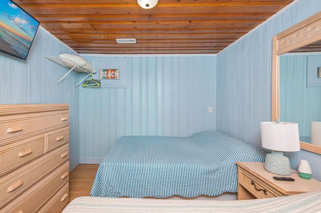 Bedroom featuring wooden ceiling, wood finished floors, and wood walls | Image 32
