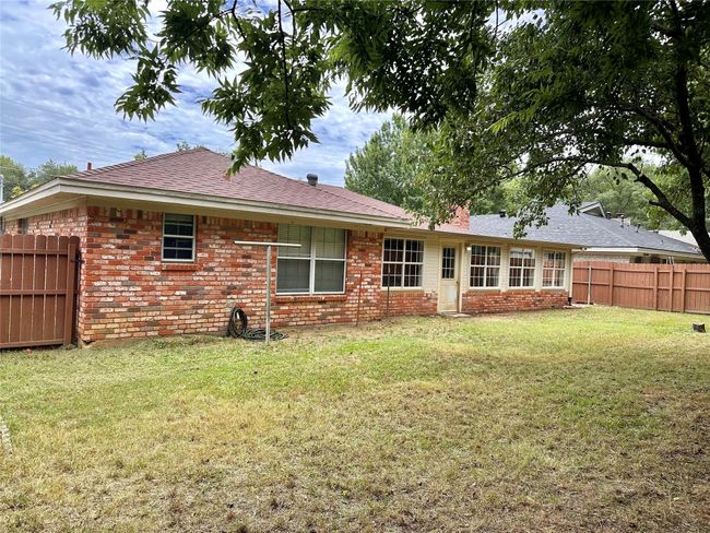 Rear view of property with brick siding and roof with shingles | Image 32