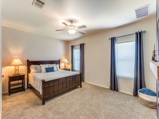 Bedroom featuring multiple windows, light colored carpet, and a ceiling fan | Image 18